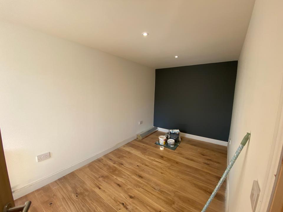 Dunnett's bedroom has a grey feature wall.