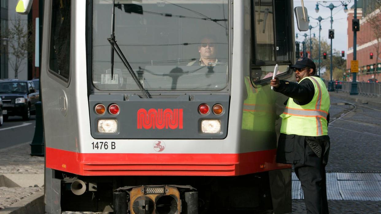 <div>muni_175_mac.jpg MUNI personel and train operators work together to make sure of the new route through the 4th and King Sts. intersection. With MUNIs new T train line now in place commuters are facing challenges at the intersection of 4th and King Sts. commuters scramble during commute time to catch connections with CalTrain just across the street. The J and T trains must wait for each other to clear the intersection before proceeding across. Photographed in, San Francisco, Ca, on 4/11/07. Photo by: Michael Macor/ The Chronicle Ran on: 04-12-2007 Evening commuters scramble from a J-Church train at Fourth and King streets, where the T-Third and J-Church lines intersect, creating the potential for delays. Passengers are feeling the effects as Muni adjusts to the new streetcar line. Ran on: 04-12-2007 Evening commuters scramble from a J-Church train at Fourth and King streets, where the T-Third and J-Church lines intersect, creating the potential for delays. Passengers are feeling the effects as Muni adjusts to the new streetcar line. ALSO Ran on: 04-15-2007 (Photo By Michael Macor/The San Francisco Chronicle via Getty Images)</div>