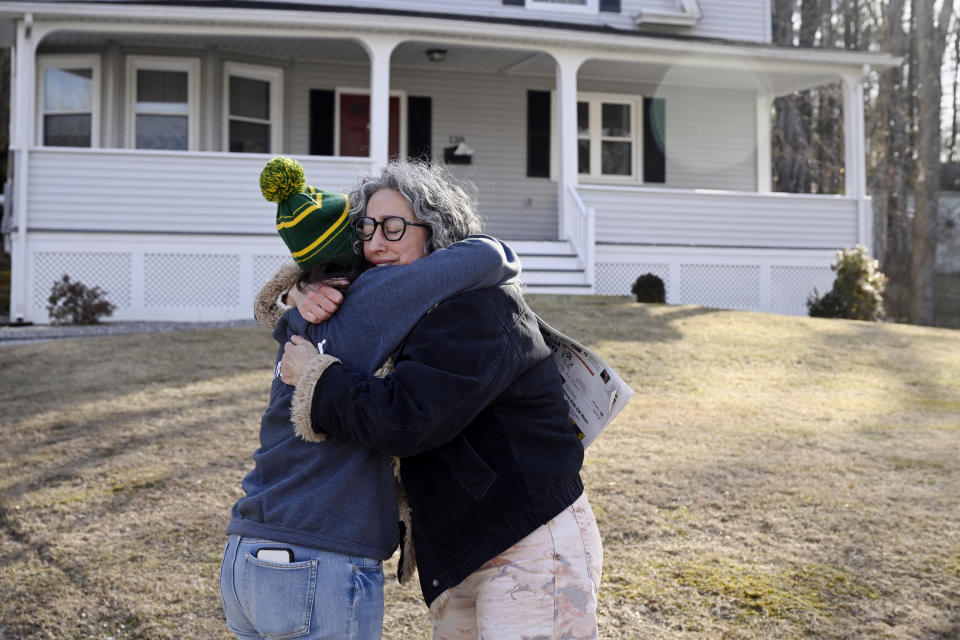 Michelle Manafy, reporter for The Winsted Citizen embraces subscriber Ruthie Ursone Napoleone while delivering the first issue of the paper in Ursone Napoleone's neighborhood, Friday, Feb. 3, 2023, in Winsted, Conn. Ursone Napoleone had several connections to the first issue, her workplace and nephew were featured in two separate stories and her father's obituary is in the paper. She stopped Manafy to ask her if she could have extra copies and said, "I wish my father could read this." At a time that local newspapers are dying at an alarming rate, longtime activist Ralph Nader is helping give birth to one. Nader put up $15,000 to help launch the Winsted Citizen and hired a veteran Connecticut journalist, Andy Thibault, to put it together. (AP Photo/Jessica Hill)