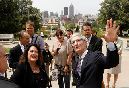Apple Chief Executive Officer Tim Cook talks with city and state representatives after discussing Apple plans to build a $1.375 billion data center in Waukee, Iowa, at the Iowa State Capitol in Des Moines, Iowa August 24, 2017. REUTERS/Scott Morgan