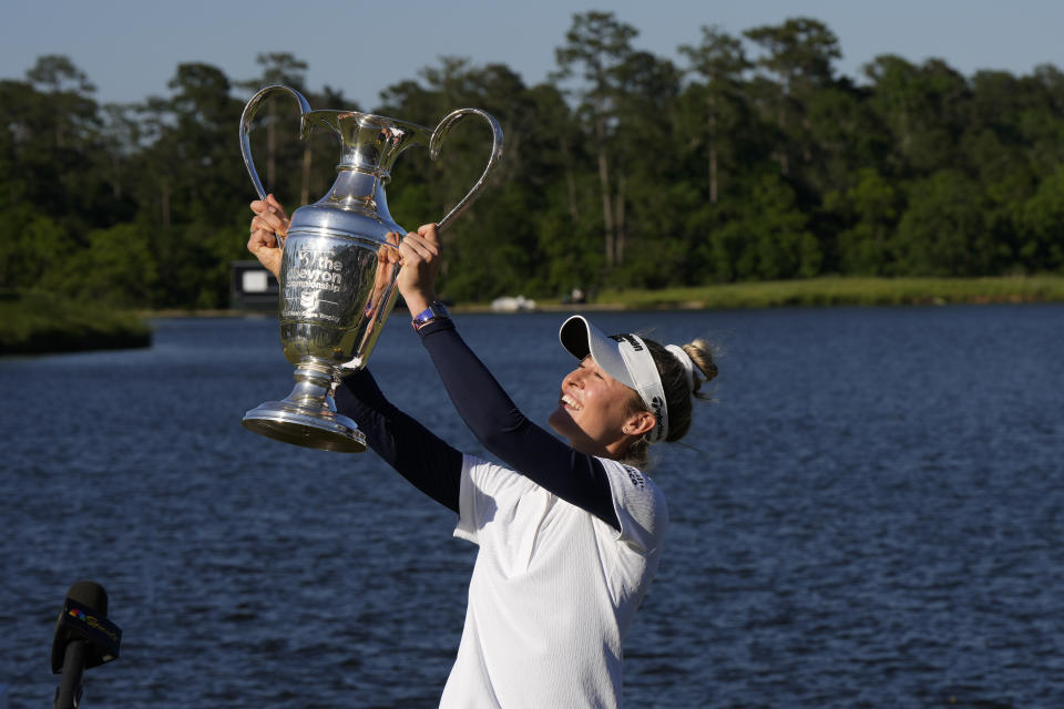 Nelly Korda holds up the trophy while celebrating her win at the Chevron Championship LPGA golf tournament Sunday, April 21, 2024, at The Club at Carlton Woods in The Woodlands, Texas. (AP Photo/David J. Phillip)