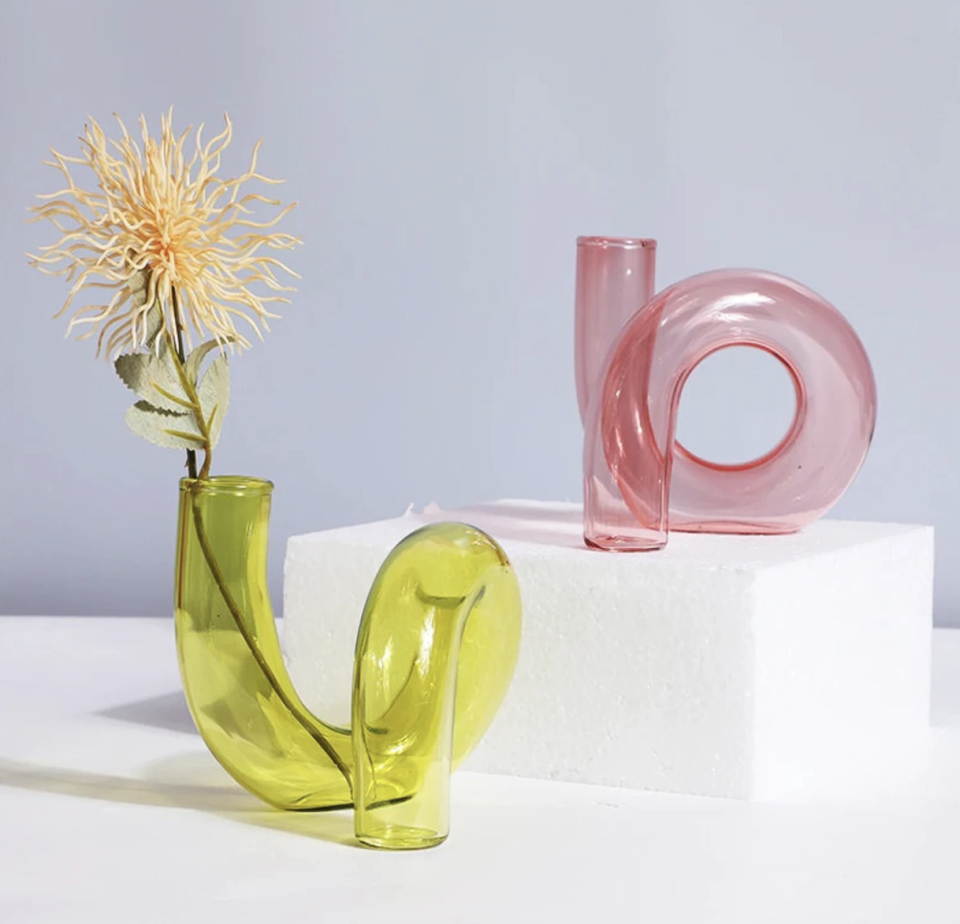 Abstract Twisted Glass Flower Vase in green and pink against light blue background (photo via Etsy)