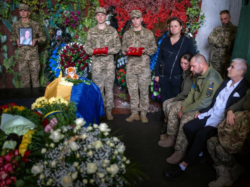 Friends and comrades-in-arms gather to bid farewell to Olga Simonova (AP)