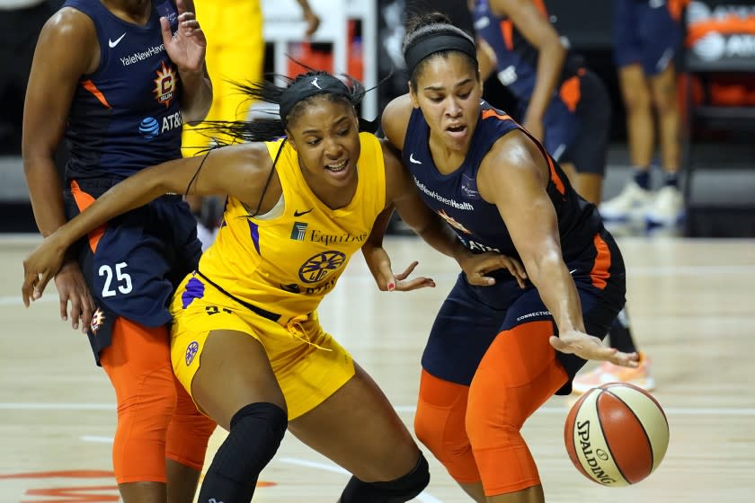 Connecticut Sun center Brionna Jones (42) steals the ball from Los Angeles Sparks center Kristine Anigwe.