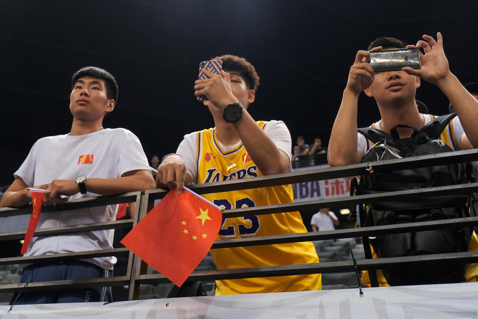 Basketball - NBA China Games - Los Angeles Lakers v Brooklyn Nets - Shenzhen, China - October 12, 2019. Fans are seen wearing LeBron James jerseys with an NBA logo covered by a Chinese national flag stickers during the game. REUTERS/Tyrone Siu