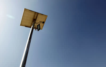 A floodlight powered by a solar panel is seen along the border fence outside the Kitton outpost on the border with Afghanistan in North Waziristan, Pakistan October 18, 2017. REUTERS/Caren Firouz