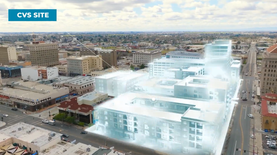 A promotional video produced by the city of Fresno depicts a large development of new apartments and a parking garage near the former CVS Pharmacy store along Tuolumne Street, at right, between Broadway Street and Van Ness Avenue in downtown Fresno.