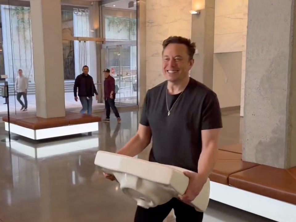 Elon Musk is shown carrying a sink into Twitter's headquarters in San Francisco