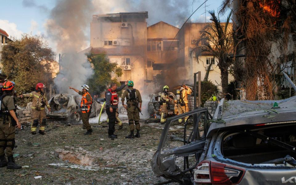 Emergency services at the scene of a Hezbollah rocket strike on Haifa