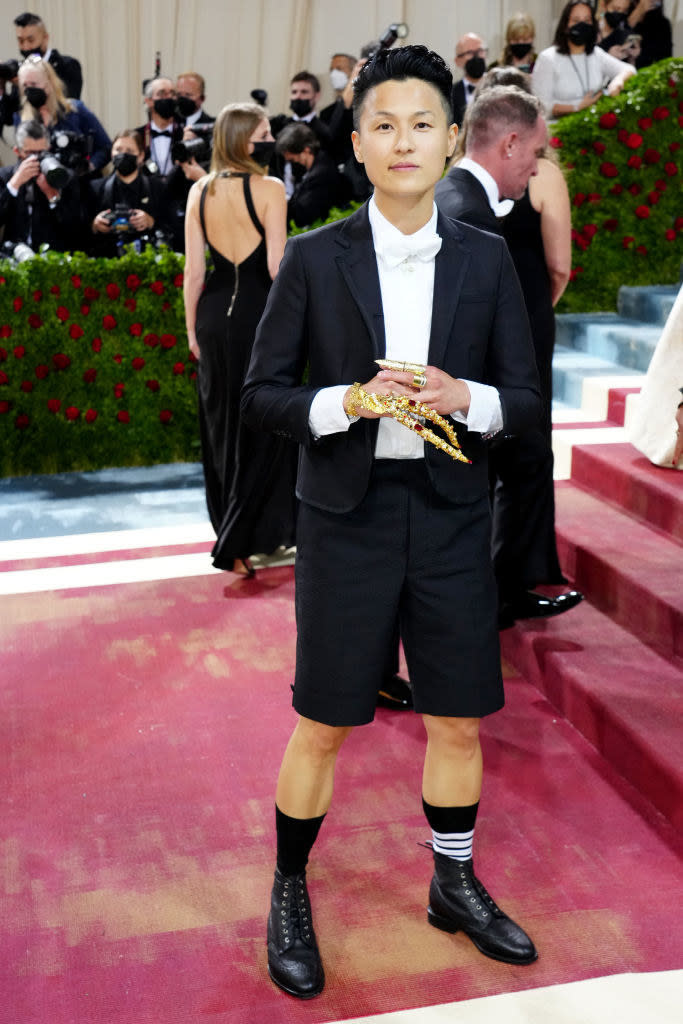 Melissa King in a tux with shorts wearing gold jewelry
