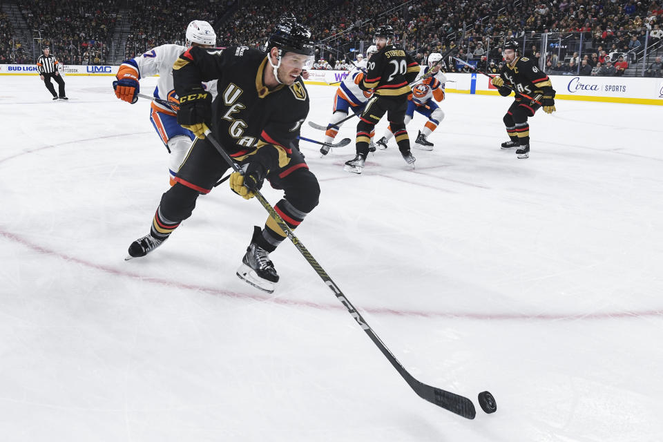 Vegas Golden Knights defenseman Brayden McNabb (3) moves the puck out of the corner during the first period of an NHL hockey game against the New York Islanders Saturday, Dec. 17, 2022, in Las Vegas. (AP Photo/Sam Morris)