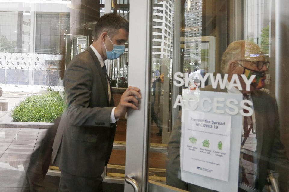 Former police officer Thomas Lane, left, follows his attorney, Earl Gray, as he left court Monday, June 29, 2020.  / Credit: Jim Mone / AP