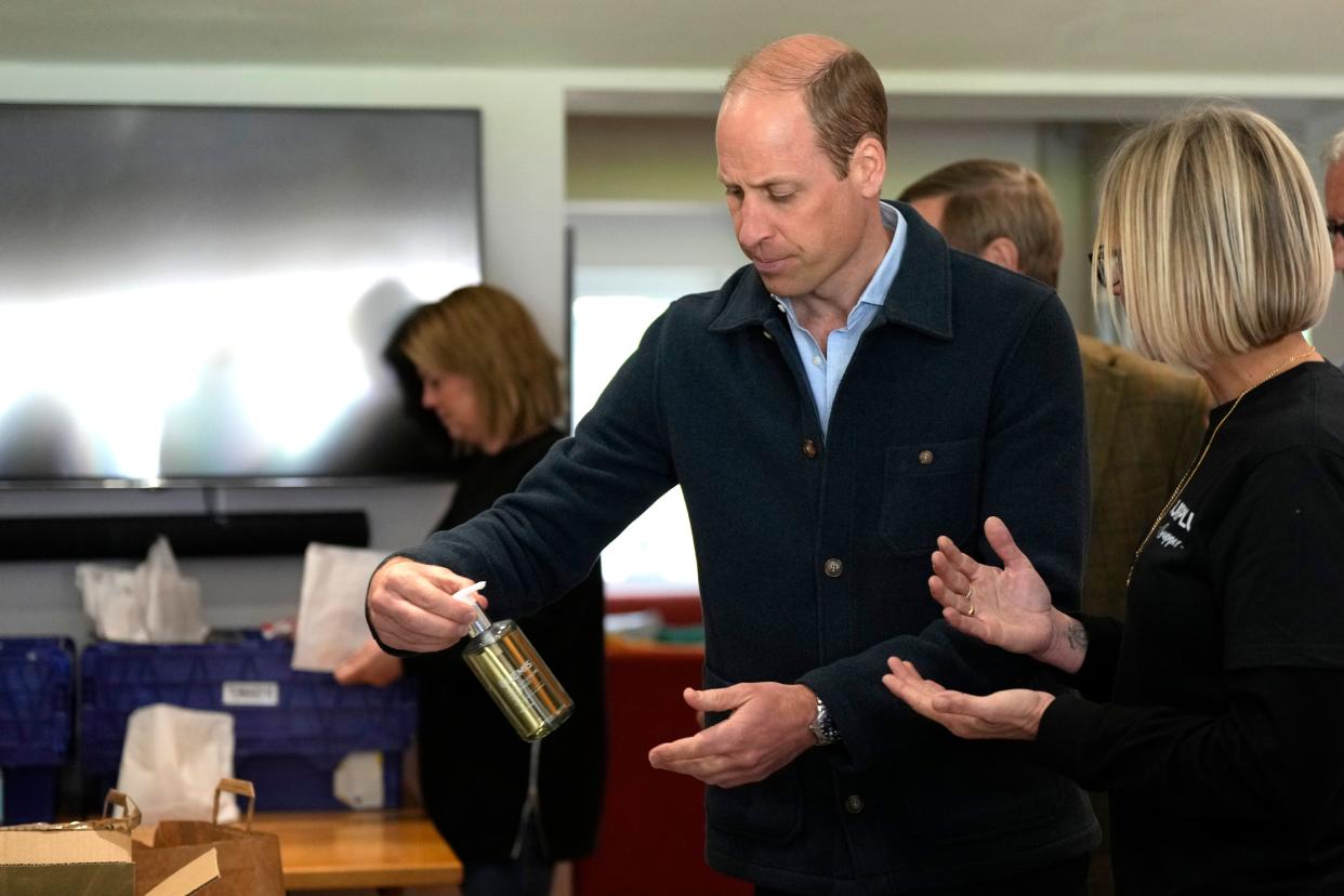 Prince William, Prince of Wales is shown items by Claire Hopkins, Operations Director, right, during a visit to Surplus to Supper, in Sunbury-on-Thames on April 18, 2024, in Surrey, England. The Prince visited Surplus to Supper, a surplus food redistribution charity, to learn about its work bridging the gap between food waste and food poverty across Surrey and West London.