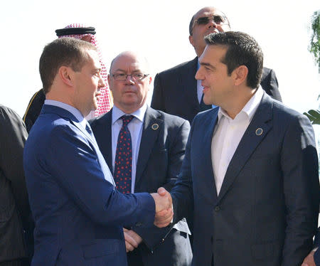 Russian Prime Minister Dmitry Medvedev talks with Greek Prime Minister Alexis Tsipras during the second day of the international conference on Libya in Palermo, Italy, November 13, 2018. Sputnik/Alexander Astafyev/Handout via REUTERS ATTENTION EDITORS - THIS IMAGE WAS PROVIDED BY A THIRD PARTY.