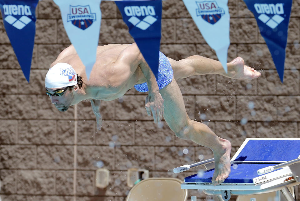 Michael Phelps dives during practice, Wednesday, April 23, 2014, in Mesa, Ariz., as he prepares to compete for the first time since retiring after the 2012 London Games. The 22-time Olympic medalist is entered in three events at the Arena Grand Prix starting Thursday. (AP Photo/Matt York)