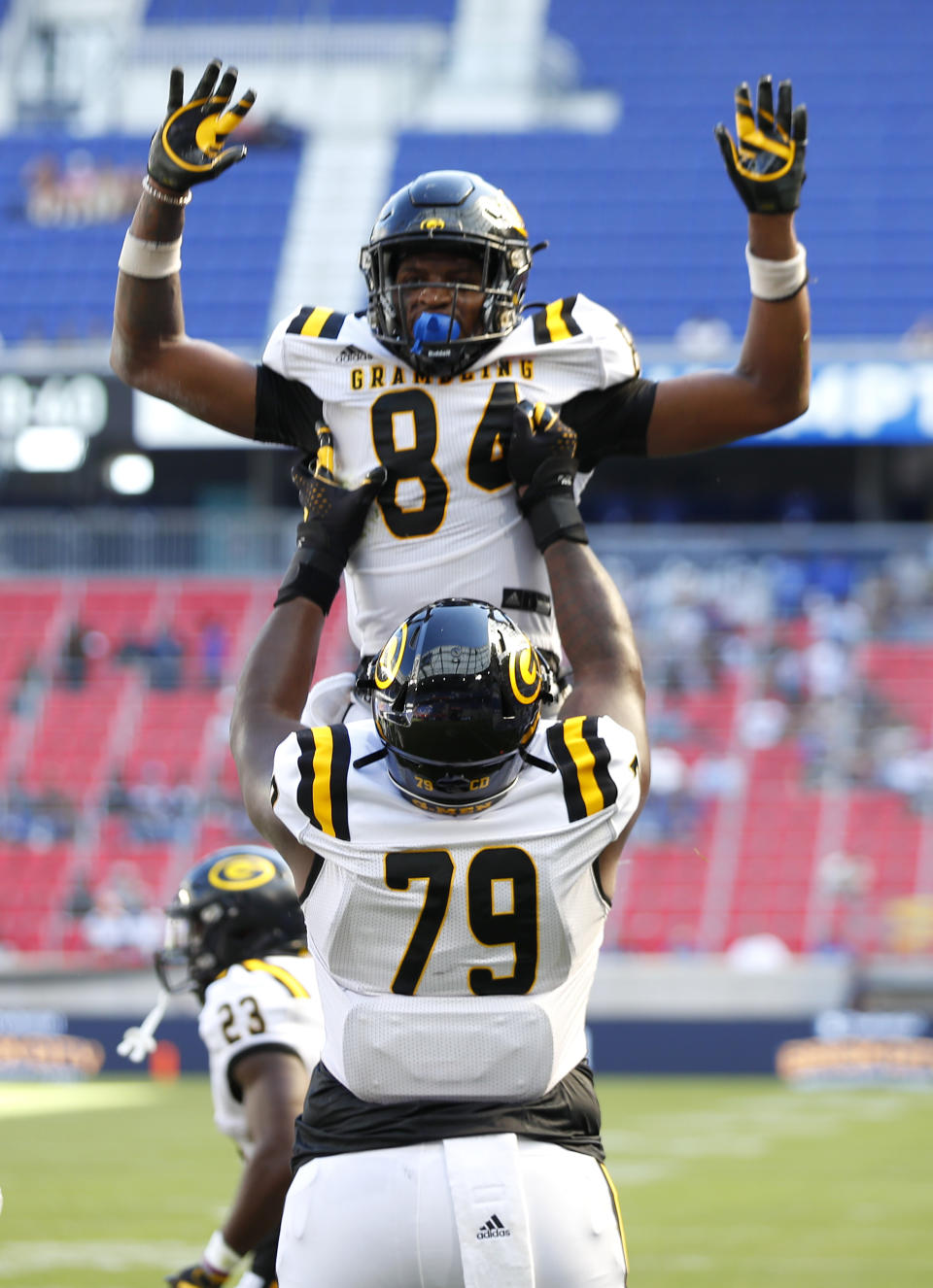 Grambling State tight end Joshua Quiett (84) celebrates with Ashanti Cole (79) after scoring a touchdown against Hampton during the first half of an NCAA college football game, Saturday, Sept. 2, 2023, in Harrison, N.J. (AP Photo/Noah K. Murray)