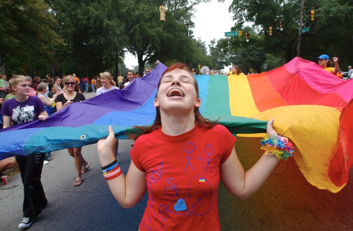 Ariel Frawley of Wake Forest helps carry the large diversity flag at the 2005 NC Gay Pride Parade in Durham, NC. The first Pride parade in Durham was June 27, 1981, and it was called Our Day Out.