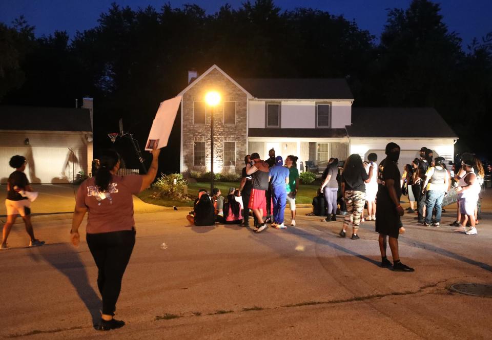 Protesters gather in front of the home of Charles Brown, Akron's deputy mayor for public safety, Thursday night to protest the police shooting death of Jayland Walker.
