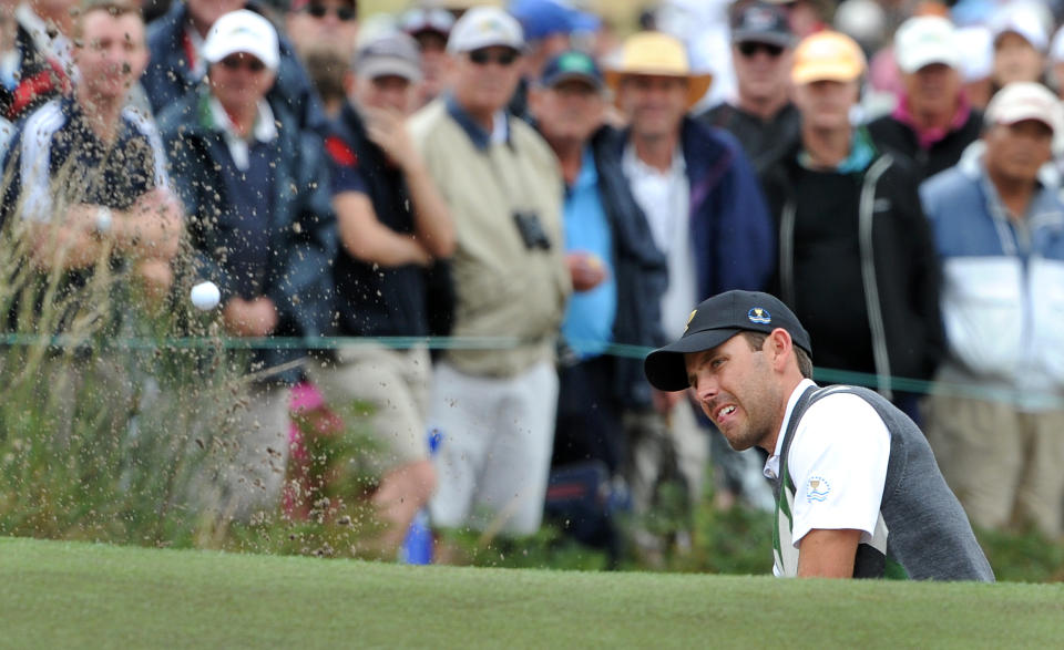 EDITORIAL USE ONLY - STRICTLY NO COMMERCIAL USE Charl Schwartzel of South Africa chip out of a bunker on the third day of the President's Cup golf tournament at the Royal Melbourne golf course in Melbourne on November 19, 2011. A non-European International team, comprising golfers from Australia, South Africa, Japan and South Korea, is taking on the US for the Presidents Cup trophy. AFP PHOTO / WILLIAM WEST (Photo credit should read WILLIAM WEST/AFP/Getty Images)