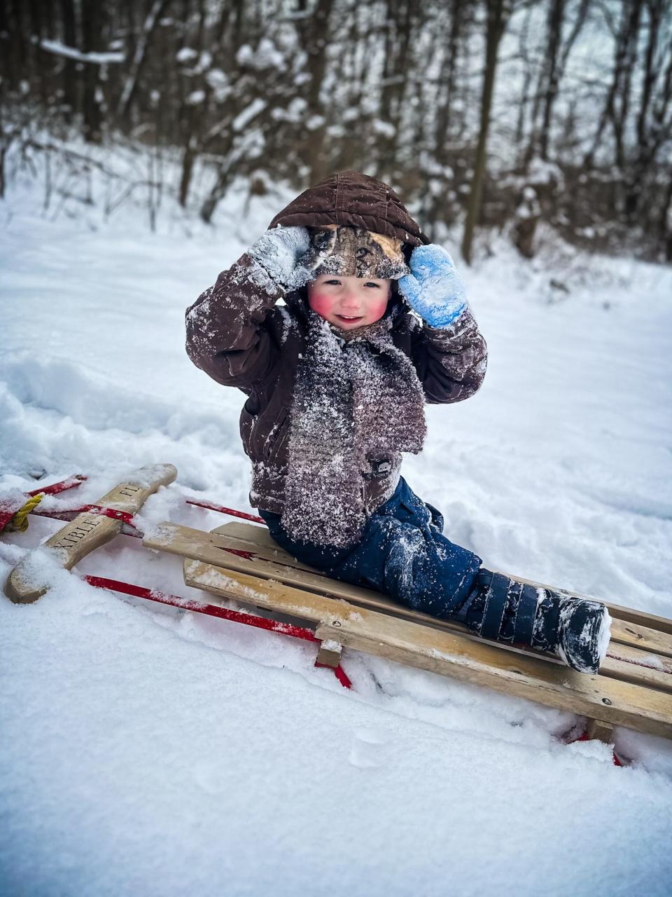 Hunter Ellwood, 2, son of Joey and Amy Ellwood, plays in the snow in Mill Township.