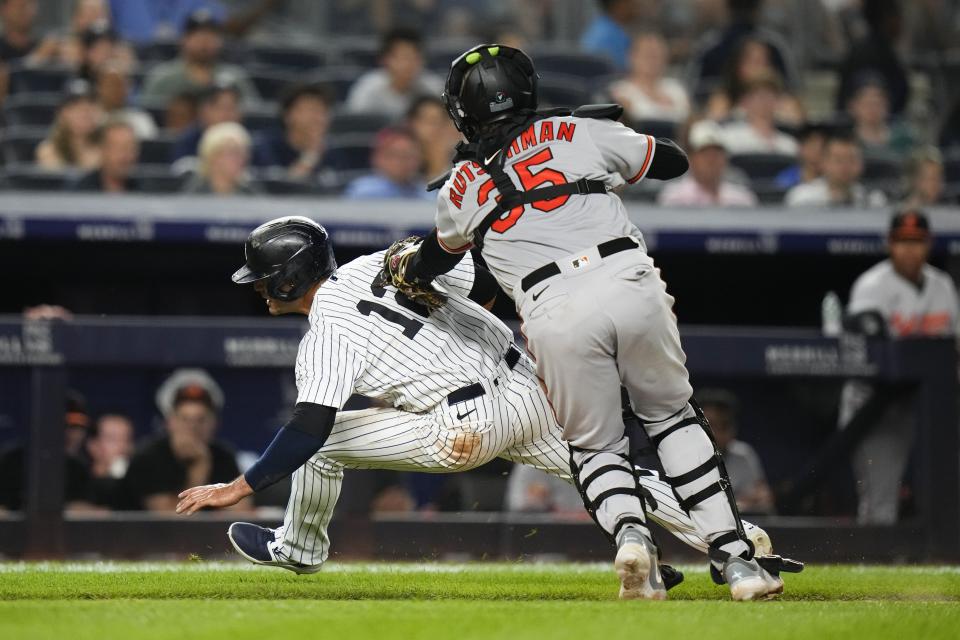 Baltimore Orioles catcher Adley Rutschman (35) tags out New York Yankees' Isiah Kiner-Falefa (12) during the seventh inning of a baseball game Monday, July 3, 2023, in New York. (AP Photo/Frank Franklin II)