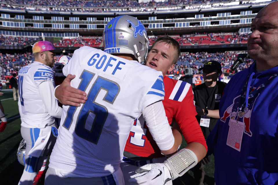 Detroit Lions quarterback Jared Goff (16) embraces New England Patriots quarterback Bailey Zappe, right, following an NFL football game, Sunday, Oct. 9, 2022, in Foxborough, Mass. (AP Photo/Charles Krupa)