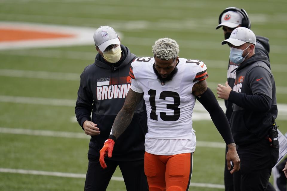 Cleveland Browns' Odell Beckham Jr. (13) leaves the field after being injured during the first half of an NFL football game against the Cincinnati Bengals, Sunday, Oct. 25, 2020, in Cincinnati. Browns star wide receiver Odell Beckham Jr. will miss the rest of the season after tearing a knee ligament during Sunday's 37-34 win at Cincinnati. (AP Photo/Michael Conroy)