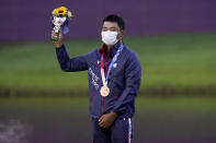 Bronze medal winner C.T. Pan, of Taiwan, stands on the podium after the men's golf event at the 2020 Summer Olympics, Sunday, Aug. 1, 2021, at the Kasumigaseki Country Club in Kawagoe, Japan, (AP Photo/Matt York)