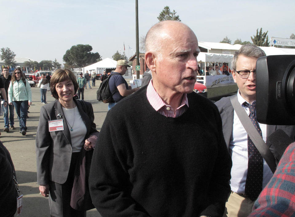 Gov. Jerry Brown talks about the politics of California’s drought in a brief visit to the 47th Annual World Ag Expo Wednesday, Feb. 12, 2014, in Tulare, Calif. Brown’s visit followed his emergency drought declaration in January and comes before President Barack Obama’s visit to the region planned for Friday. At left is Karen Ross, secretary of the California Department of Food and Agriculture. (AP Photo/Scott Smith)