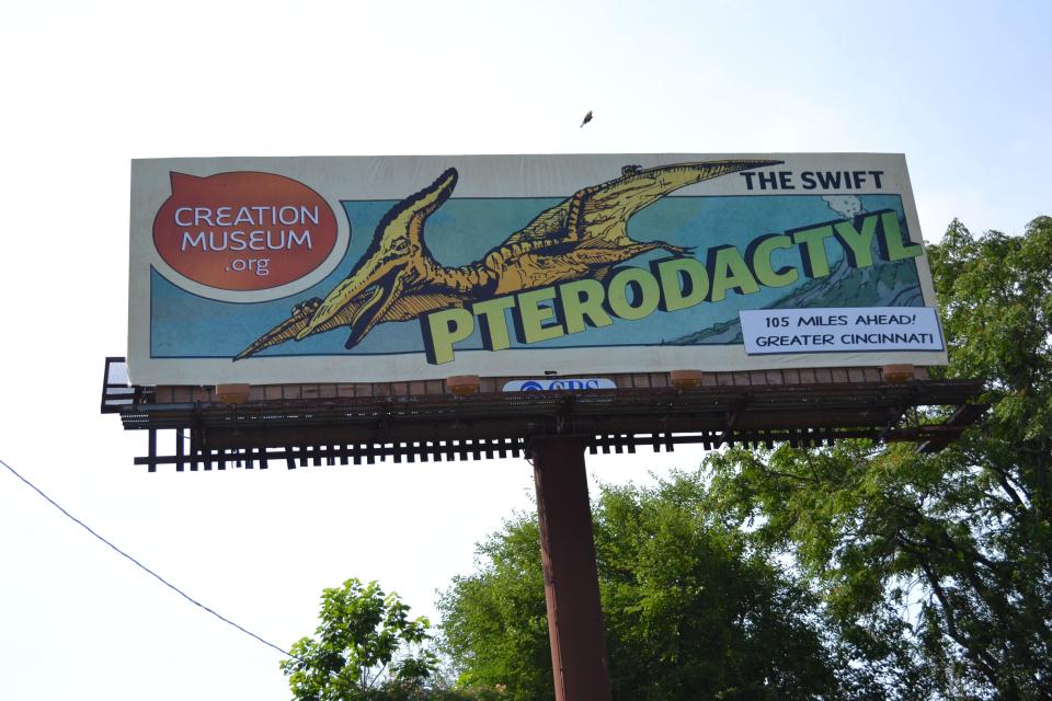 A billboard in Louisville, Ky., shows a new ad campaign for the Creation Museum, on June 11, 2012. A new nationwide billboard ad campaign is using dinosaurs to attract visitors to the Bible-based center near Cincinnati. The museum has exhibits that challenge evolution science and promote a literal interpretation of the Old Testament's creation story. (AP Photo/Dylan Lovan)