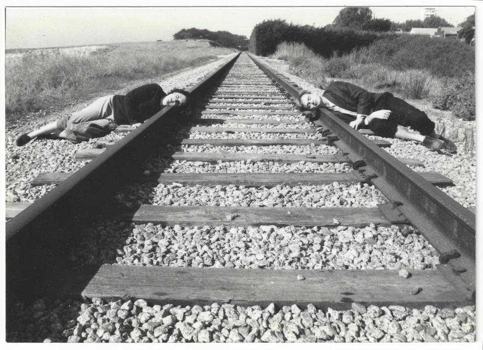 Christopher Nolan and Emma Thomas lying on train tracks during a vacation in California.