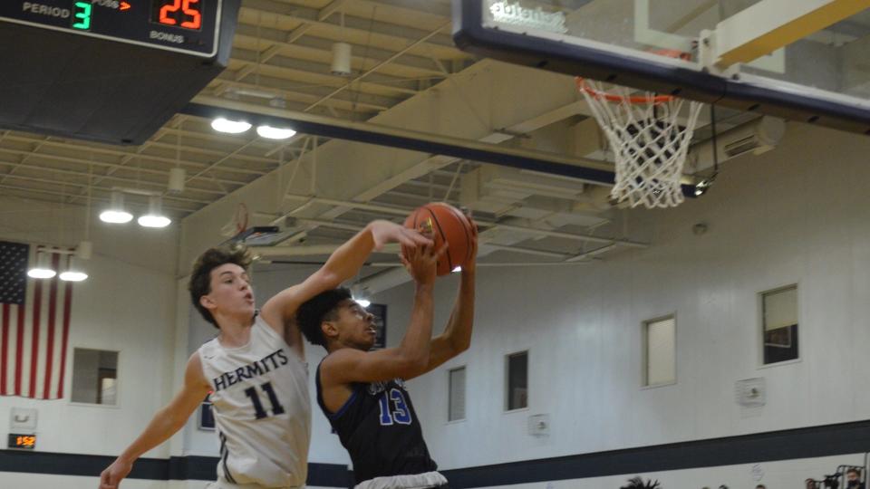 St. Augustine's Matt Kouser (11) gets a hand on Tayshaun Jackson's shot during the second quarter of their Cape-Atlantic League game on Wednesday, January 26, 2022.