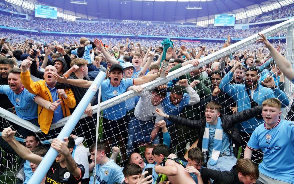 Manchester City fans invade the pitch - PA