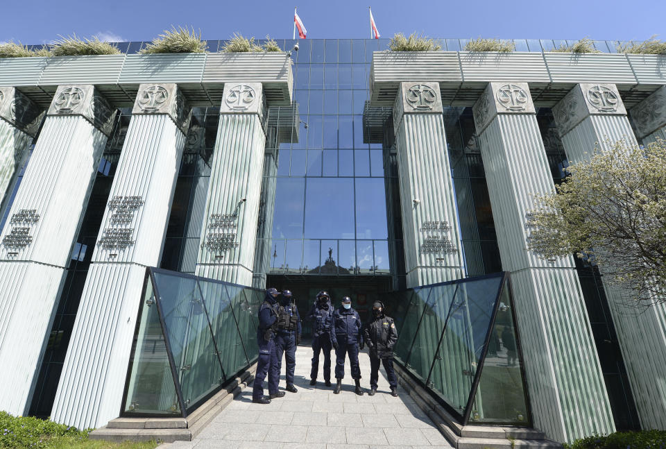 Police stand outside the Supreme Court in Warsaw, Poland, on Thursday May 6, 2021. Inside the Disciplinary Chamber of the court was examining the case of a judge. A top European Union legal advisor argued in an opinion Thursday that the chamber for disciplining judges is contrary to EU law.(AP Photo/Czarek Sokolowski)