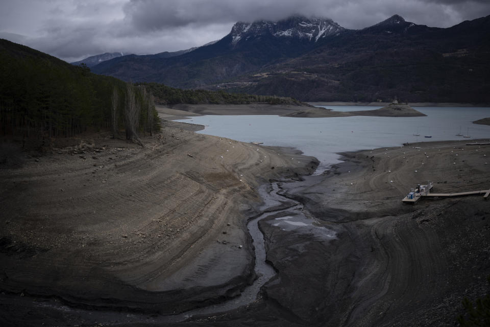 FILE - A usually submerged section of the lake Serre-Poncon in southern France, Tuesday, March 14, 2023. French President Emmanuel Macron presents Thursday March 30, 2023 a plan for saving France's water after exceptional winter drought, February wildfires and violence between protesters and police over an agricultural reservoir. (AP Photo/Daniel Cole, File)