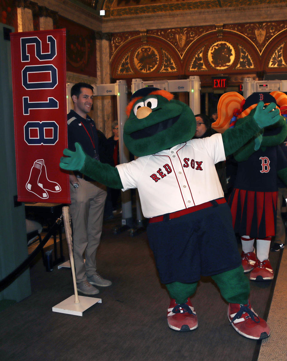 Boston Red Sox mascot Wally the Green Monster walks the red carpet prior to the premiere of "The 2018 World Series: Damage Done," documentary production that captures video moments of the Red Sox's march towards the 2018 World Series Championship, Monday, Dec. 3, 2018. (AP Photo/Charles Krupa)