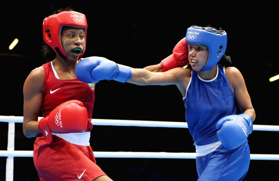 LONDON, ENGLAND - AUGUST 05: Karlha Magiliocco of Venuzuela (R) in action with Erica Matos of Brazil during the Women's Fly (48-51kg) Boxing on Day 9 of the London 2012 Olympic Games at ExCeL on August 5, 2012 in London, England. (Photo by Scott Heavey/Getty Images)