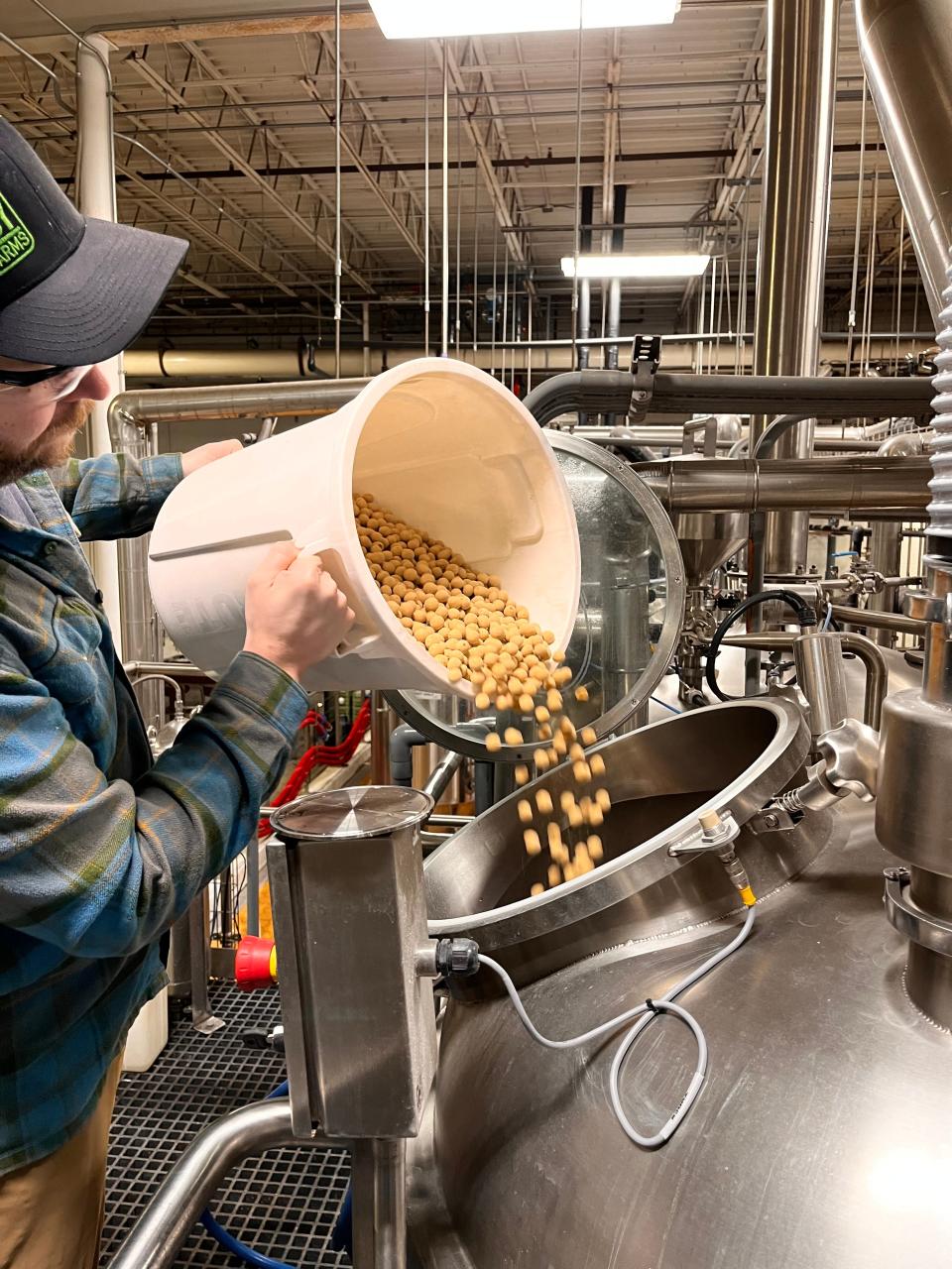 Malted milk balls are added while making Dogfish Head's newest brew in Milton: the 7.3% ABV Maibock beer named Balls Back Bock.