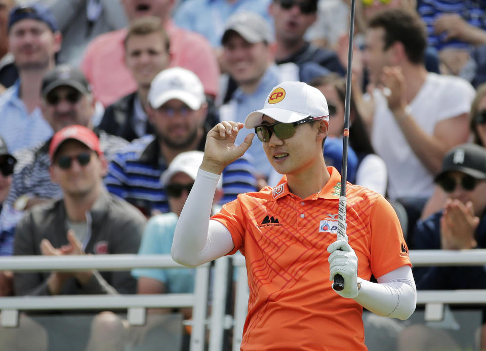 Jazz Janewattananond, of Thailand, acknowledges applause from spectators before driving off the first tee during the final round of the PGA Championship golf tournament, Sunday, May 19, 2019, at Bethpage Black in Farmingdale, N.Y. (AP Photo/Seth Wenig)
