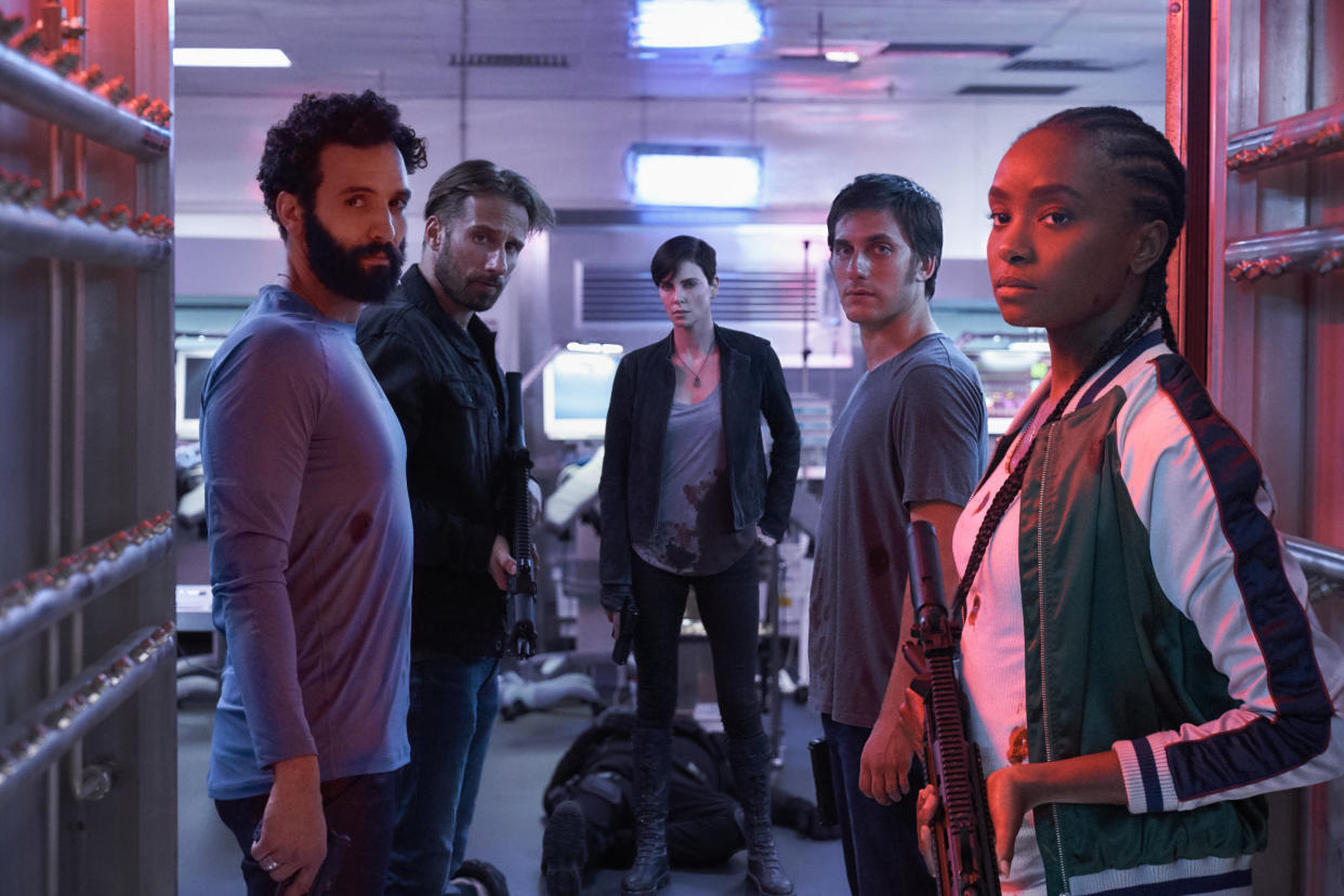 THE OLD GUARD (2020) -  (L to R) Marwan Kenzari as Joe,  Matthias Schoenaerts as Booker, Charlize Theron as Andy,  Luca Marinelli as Nicky, Kiki Layne as Nile.   Photo Credit: AIMEE SPINKS/NETFLIX ©2020