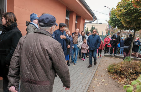 People are queueing to cast their votes during the Polish regional elections, outside a polling station in Poznan, Poland, October 21, 2018. Piotr Skornicki/Agencja Gazeta via REUTERS