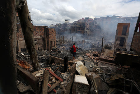 A resident is seen after a fire at Educandos neighbourhood, on a branch of the Rio Negro, a tributary to the Amazon river, in the city of Manaus, Brazil December 18, 2018. REUTERS/Bruno Kelly