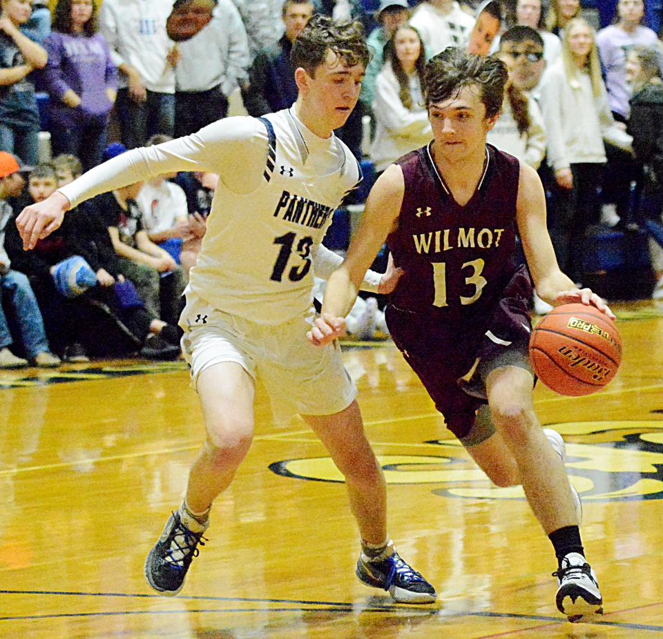 Wilmot's Dennis Creadon (13) drives against Great Plains Lutheran's Alex Heil during their high school boys basketball game Friday night in Watertown. Great Plains Lutheran won 60-36.