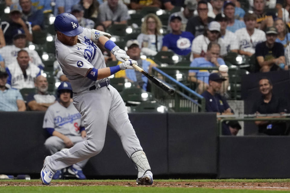 Los Angeles Dodgers' Justin Turner hits an RBI single during the 11th inning of the team's baseball game against the Milwaukee Brewers on Tuesday, Aug. 16, 2022, in Milwaukee. (AP Photo/Aaron Gash)