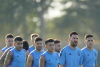 Argentina's Lionel Messi arrives with teammates for a training session on the eve of the group C World Cup soccer match against Saudi Arabia, in Doha, Monday, Nov. 21, 2022. (AP Photo/Jorge Saenz)