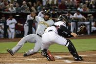 Jun 11, 2018; Phoenix, AZ, USA; Pittsburgh Pirates center fielder Starling Marte (6) scores prior to the catch by Arizona Diamondbacks catcher John Ryan Murphy (36) during the first inning at Chase Field. Mandatory Credit: Matt Kartozian-USA TODAY Sports