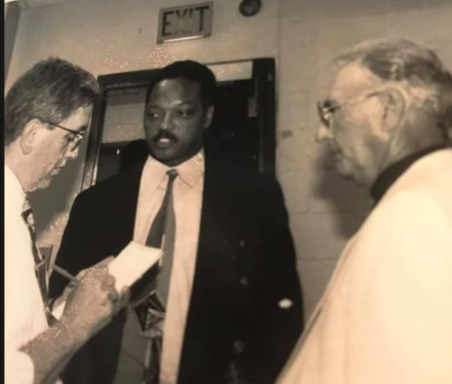 Reporter Timothy Connolly, left, interviews Jesse Jackson at the DCU Center in 1998, as Bob Cousy looks on. There was a basketball tournament taking place.