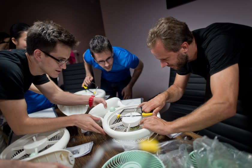 Thomas Talhelm, center, founder of Smart Air, led workshops when he was living in Beijing to demonstrate how to make a simple DIY air purifier that would protect users from breathing in dangerous particulate matter when there was poor air quality.