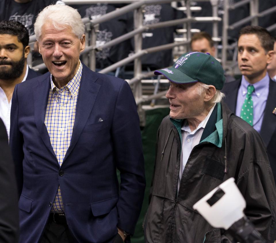 Former President Bill Clinton talks with former Milwaukee Bucks owner and Sen. Herb Kohl (right) before the Bucks playoff game against the Boston Celtics on April 26, 2018, at the BMO Harris Bradley Center in Milwaukee.