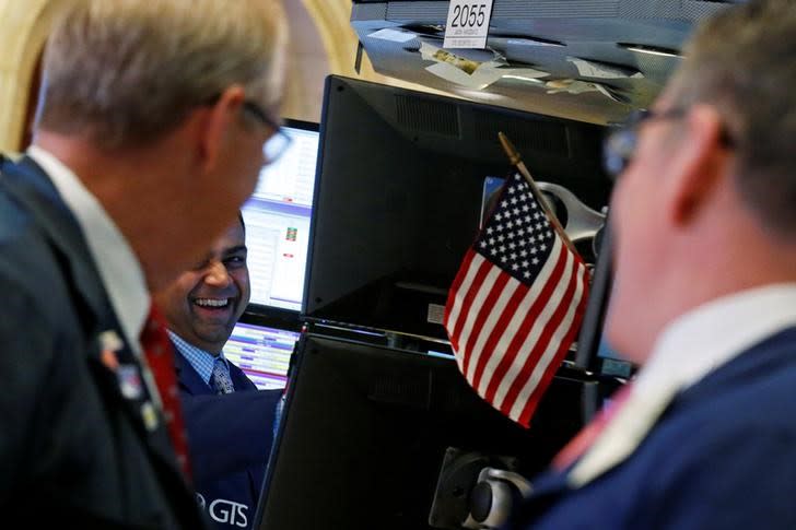 Traders work on the floor of the New York Stock Exchange (NYSE) in New York City, U.S., October 21, 2016. REUTERS/Brendan McDermid/Files